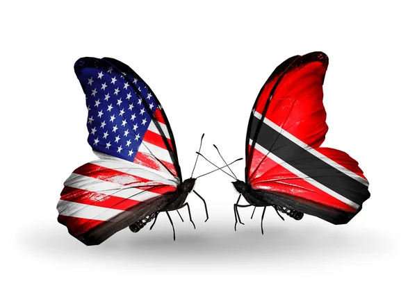 两个小蝴蝶翅膀上的标志与作为关系的象征美国、 特立尼达和多巴哥 — 图库照片