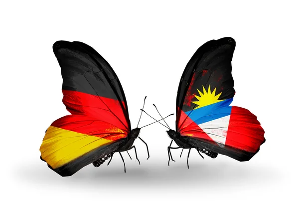 Two butterflies with flags on wings as symbol of relations Germany and Antigua and Barbuda — Stock Photo, Image