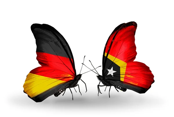 Deux papillons avec des drapeaux sur les ailes comme symbole des relations Allemagne et Timor oriental — Photo