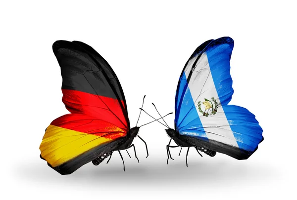 Two butterflies with flags on wings as symbol of relations Germany and Guatemala — Stock Photo, Image