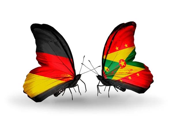 Dwa motyle z flagami na skrzydłach jako symbol stosunków, Niemcy i grenada — Zdjęcie stockowe