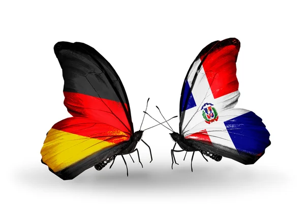 Two butterflies with flags on wings as symbol of relations Germany and Dominicana — Stock Photo, Image