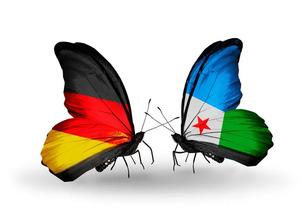 Dva motýli s příznaky na křídlech jako symbol vztahů, Německo a Džibuti — Stock fotografie