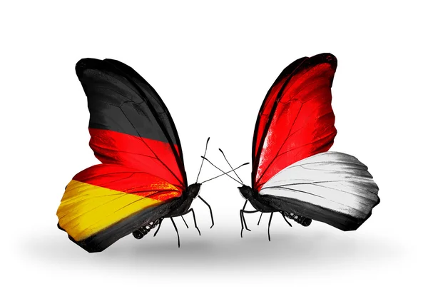 Two butterflies with flags on wings as symbol of relations Germany and Monaco or Indonesia — Stock Photo, Image