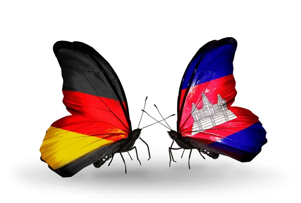 Dva motýli s příznaky na křídlech jako symbol vztahů, Německo a Kambodža — Stock fotografie