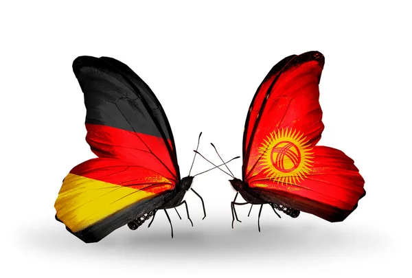 Due farfalle con bandiere sulle ali come simbolo delle relazioni Germania e Kirghiz — Foto Stock