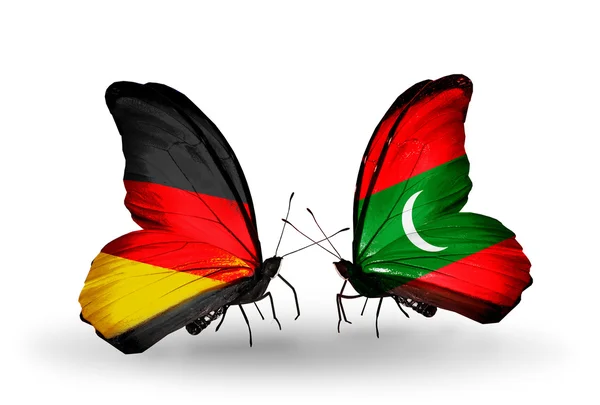 Two butterflies with flags on wings as symbol of relations Germany and Maldives — Stock Photo, Image