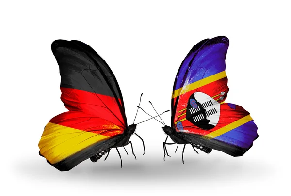 Dos mariposas con banderas en alas como símbolo de relaciones Alemania y Suiza — Foto de Stock