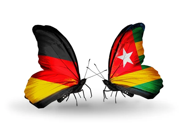 Duas borboletas com bandeiras em asas como símbolo de relações Alemanha e Togo — Fotografia de Stock