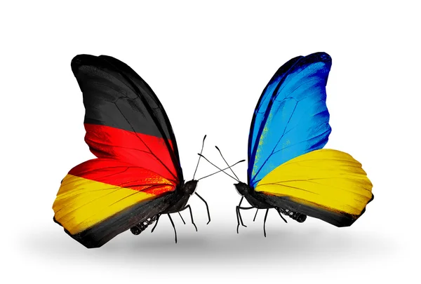 Dos mariposas con banderas en alas como símbolo de relaciones Alemania y Ucrania — Foto de Stock