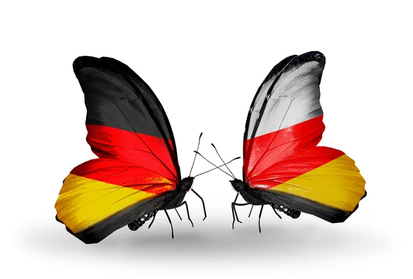 Dwa motyle z flagami na skrzydło symbol stosunki Niemiec i Osetii Południowej — Zdjęcie stockowe