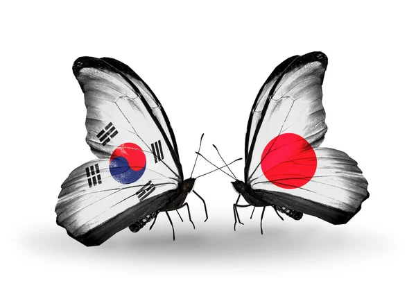 Two butterflies with flags on wings as symbol of relations South Korea and Japan — ストック写真