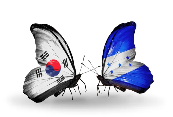 Dos mariposas con banderas en alas como símbolo de relaciones Corea del Sur y Honduras —  Fotos de Stock