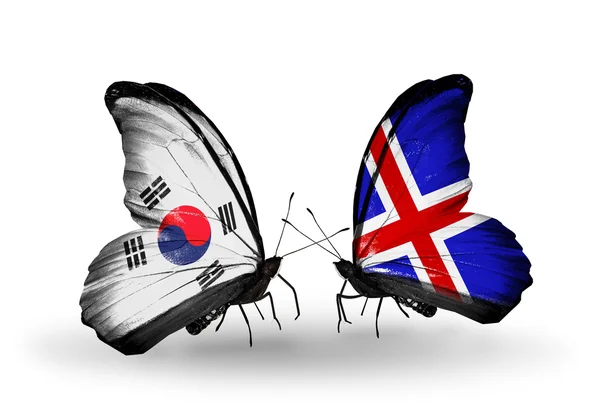 Due farfalle con bandiere sulle ali come simbolo delle relazioni Corea del Sud e Islanda — Foto Stock
