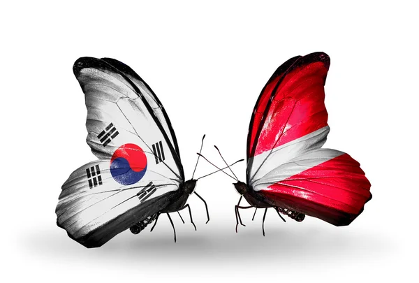 Two butterflies with flags on wings as symbol of relations South Korea and Latvia — Stock Photo, Image