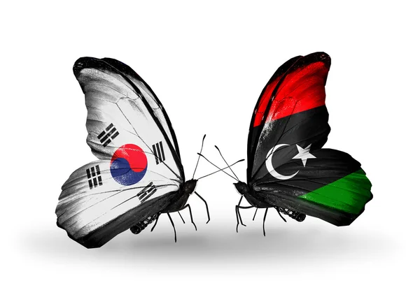 Dos mariposas con banderas en alas como símbolo de relaciones Corea del Sur y Libia — Foto de Stock
