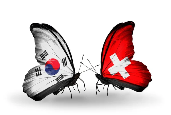 Two butterflies with flags on wings as symbol of relations South Korea and Switzerland — Stock Photo, Image