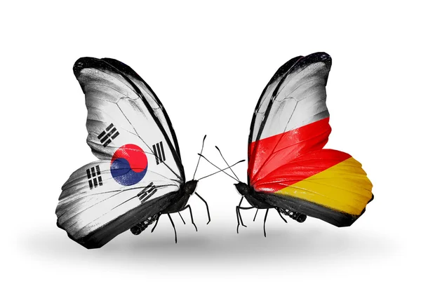 Two butterflies with flags on wings as symbol of relations South Korea and South Ossetia — Stock Photo, Image