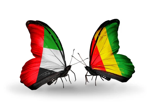 Dos mariposas con banderas en alas como símbolo de relaciones Emiratos Árabes Unidos y Guinea — Foto de Stock