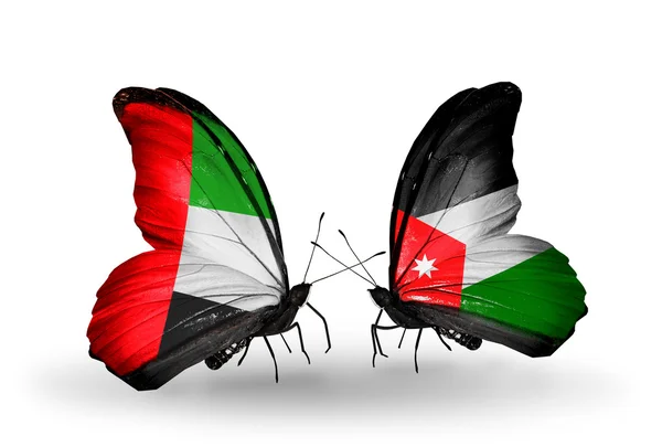 Deux papillons avec des drapeaux sur les ailes comme symbole des relations EAU et Jordanie — Photo