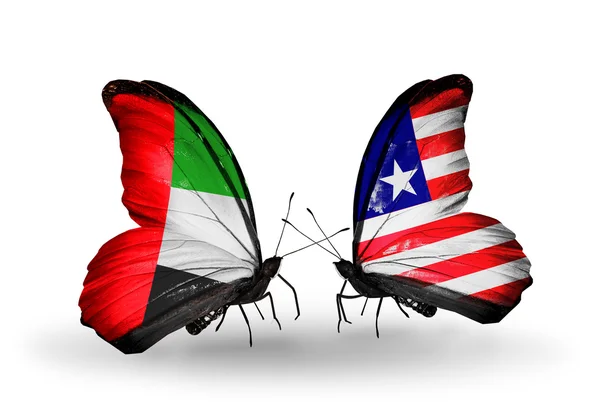 两只蝴蝶带有标志的符号关系阿联酋和利比里亚的翅膀 — 图库照片