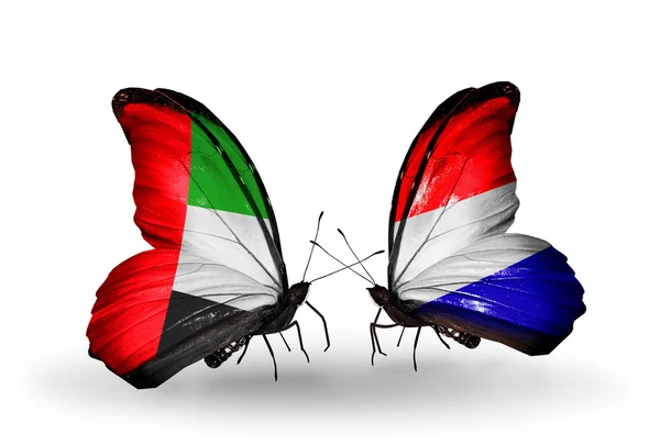 Two butterflies with flags on wings as symbol of relations UAE and Holland — Stock Photo, Image