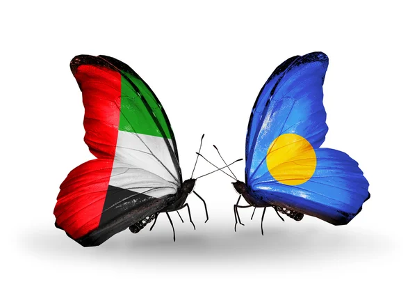 Two butterflies with flags on wings as symbol of relations UAE and Palau — Stock Photo, Image