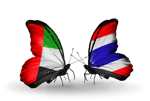 Dua kupu-kupu dengan bendera di sayap sebagai simbol hubungan UEA dan Thailand — Stok Foto