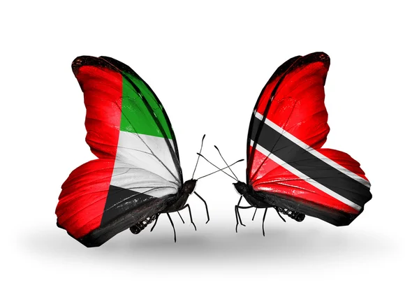 Duas borboletas com bandeiras nas asas como símbolo das relações Emirados Árabes Unidos e Trinidad e Tobago — Fotografia de Stock