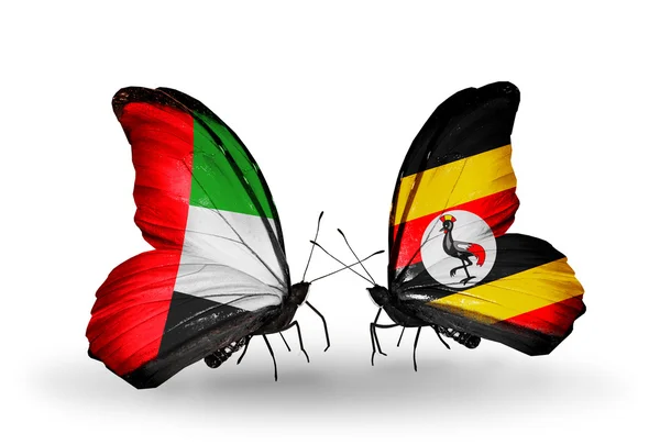 Two butterflies with flags on wings as symbol of relations UAE and Uganda — Stock Photo, Image