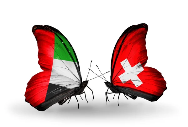 Zwei Schmetterlinge mit Flügelfahnen als Symbol der Beziehungen uae und Schweiz — Stockfoto