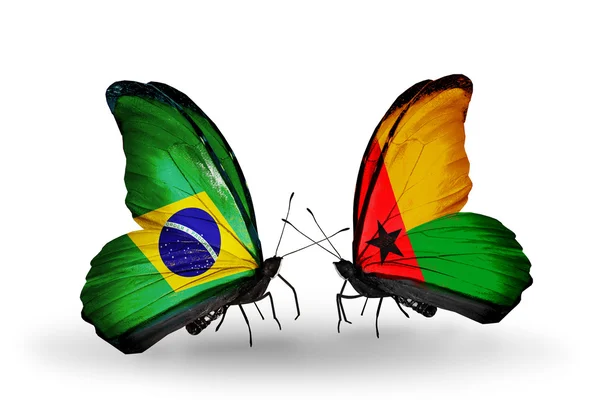 Deux papillons avec des drapeaux sur les ailes comme symbole des relations Brésil et Guinée Bissau — Photo