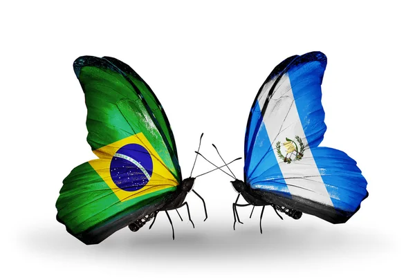 Two butterflies with flags on wings as symbol of relations Brazil and Guatemala — Stock Photo, Image