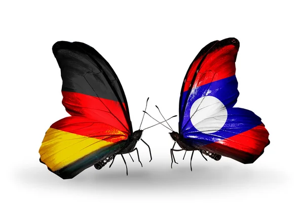 Two butterflies with flags on wings as symbol of relations Germany and Laos — Stock Photo, Image