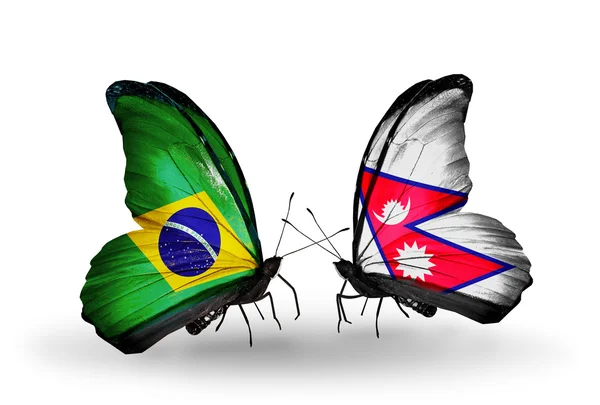 Dos mariposas con banderas en alas como símbolo de relaciones Brasil y Nepal — Foto de Stock