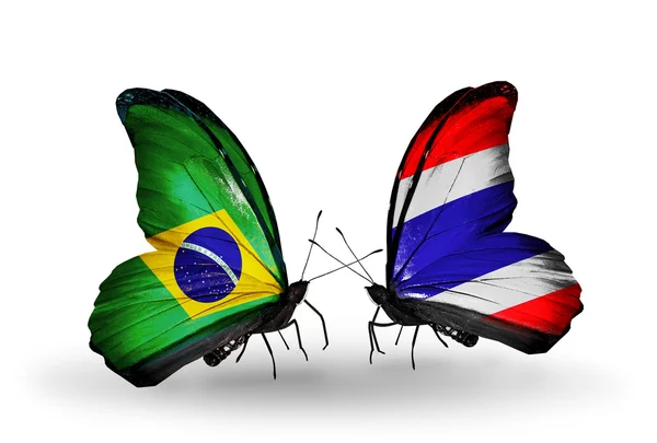Two butterflies with flags on wings as symbol of relations Brazil and Thailand — Stock Photo, Image