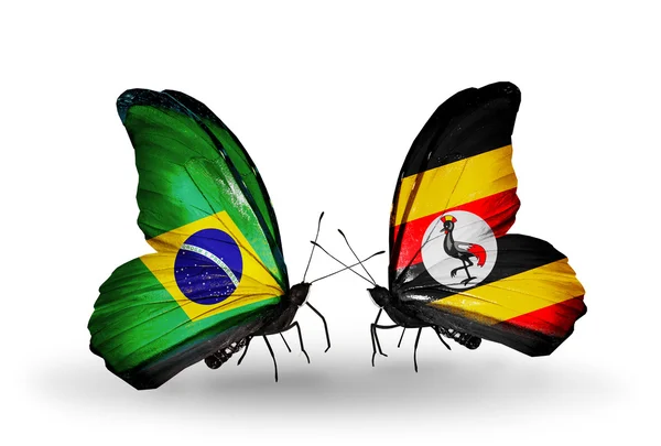 Two butterflies with flags on wings as symbol of relations Brazil and Uganda — Stock Photo, Image