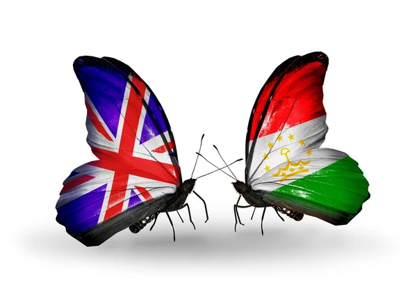 Dos mariposas con banderas en alas como símbolo de relaciones Reino Unido y Tayikistán —  Fotos de Stock