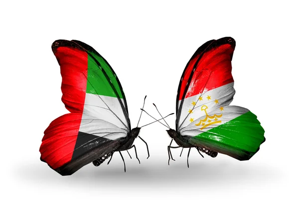 Two butterflies with flags on wings as symbol of relations UAE and Tajikistan — Stock Photo, Image