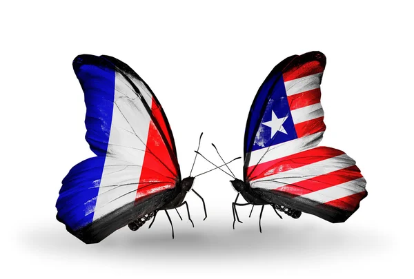 Два метелики з прапорами на крилах як символ відносин, Франції та Ліберії — стокове фото