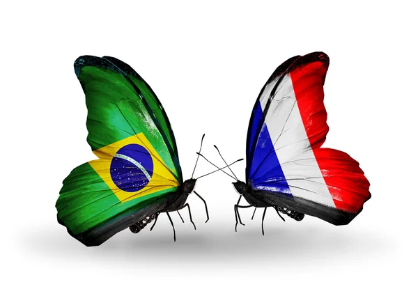 Two butterflies with flags on wings as symbol of relations Brazil and France — Stock Photo, Image