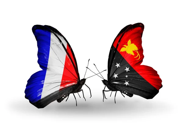 Two butterflies with flags on wings as symbol of relations France and Papua New Guinea — Stock Photo, Image