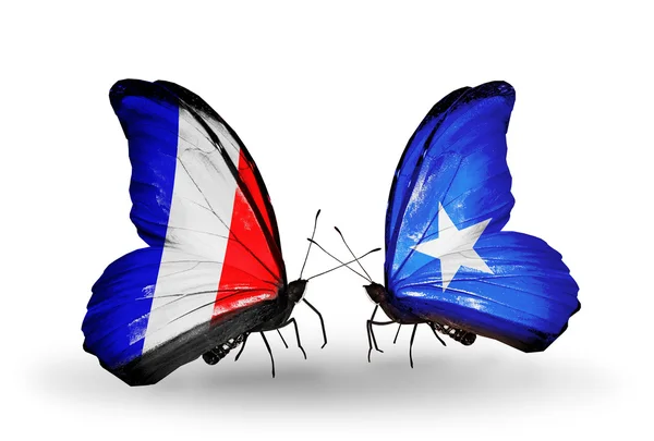 Две бабочки с флагами на крыльях как символ отношений Франции и Сомали — стоковое фото
