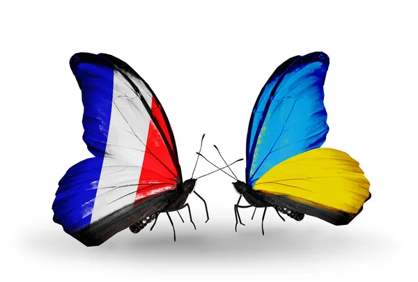 Dos mariposas con banderas en alas como símbolo de relaciones Francia y Ucrania —  Fotos de Stock