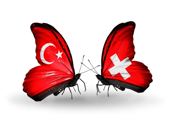 Two butterflies with flags on wings as symbol of relations Turkey and Switzerland — Stock Photo, Image