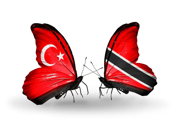 Dwa motyle z flagami na skrzydłach jako symbol Turcja stosunków i Trynidadu i tobago — Zdjęcie stockowe