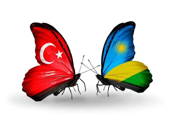 Duas borboletas com bandeiras em asas como símbolo das relações Turquia e Ruanda — Fotografia de Stock