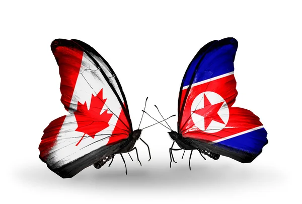 Dos mariposas con banderas en alas como símbolo de relaciones Canadá y Corea del Norte —  Fotos de Stock