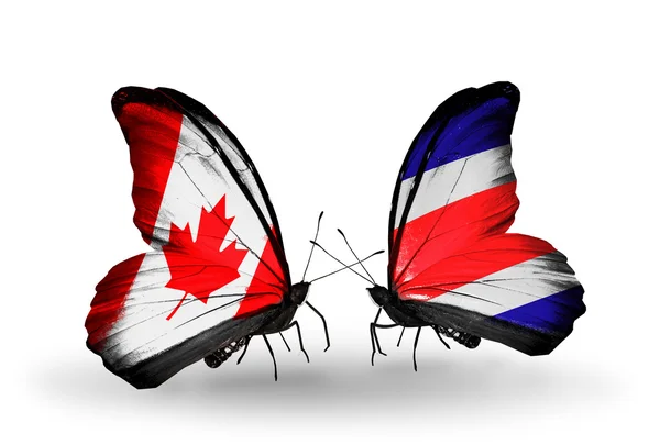 Två fjärilar med flaggor på vingarna som symbol för förbindelserna mellan Kanada och costa rica — Stockfoto