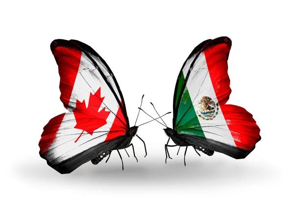 Twee vlinders met vlaggen op vleugels als symbool van de betrekkingen canada en mexico — Stockfoto